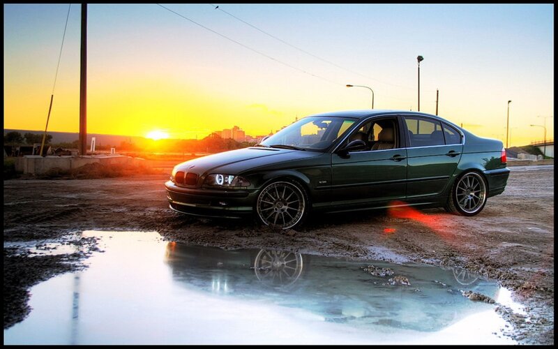 Green BMW at sunset