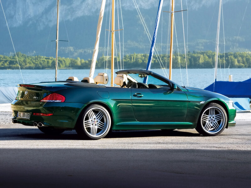 Green BMW convertible by the lake