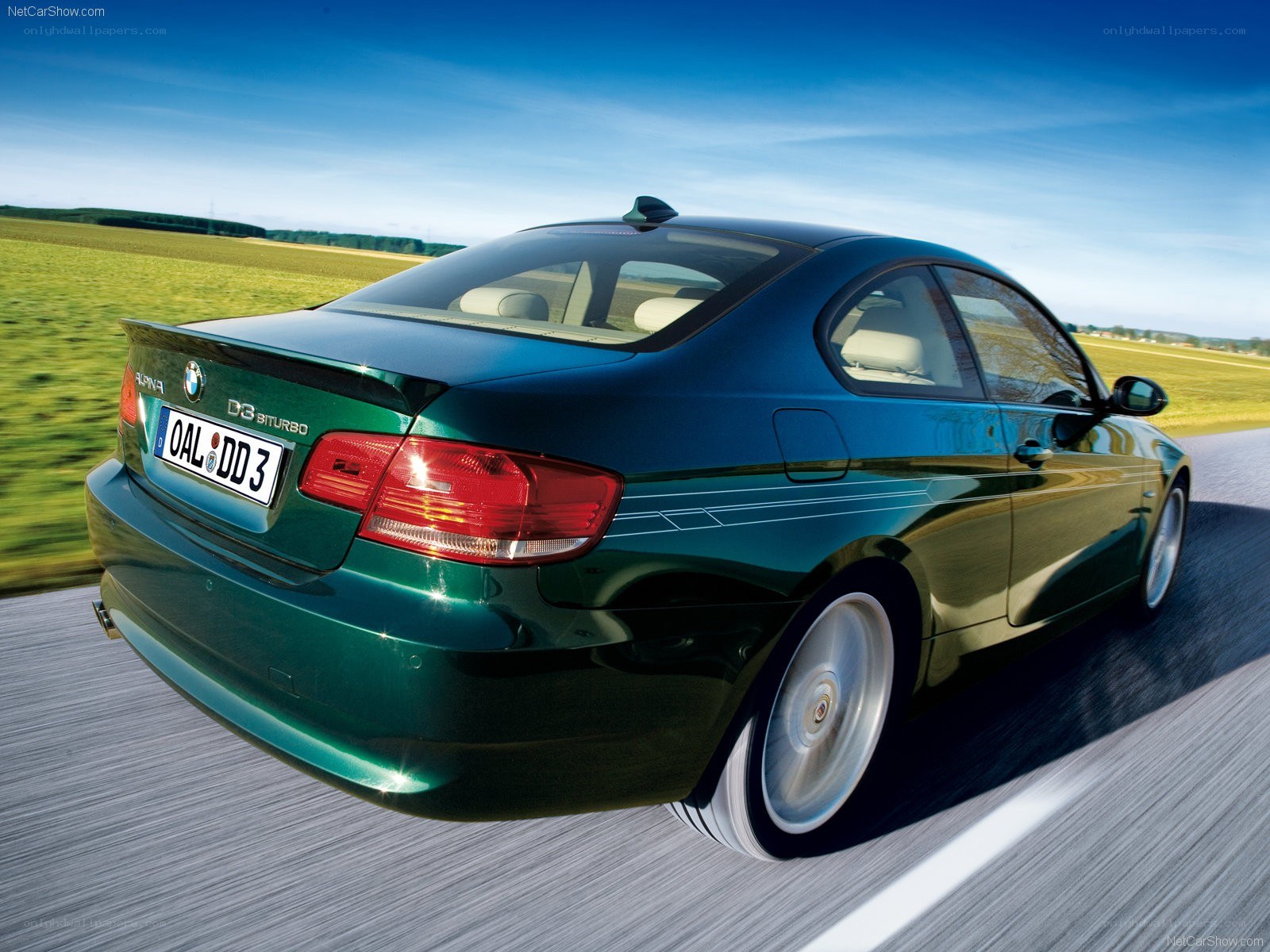green bmw driving on road