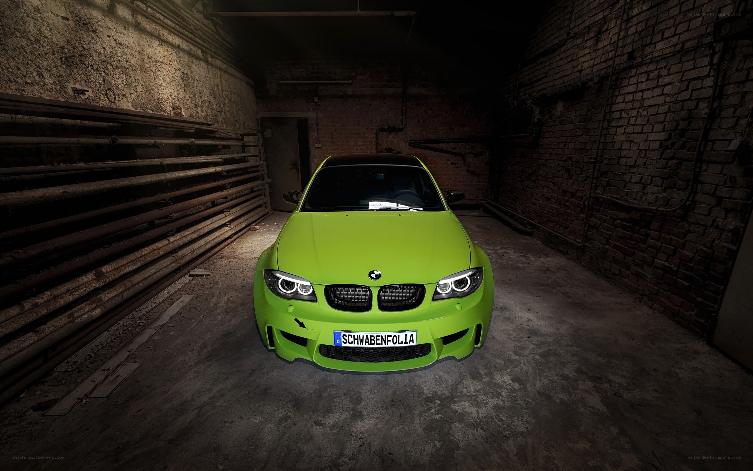 Green BMW in a warehouse