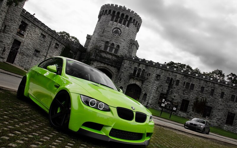 green bmw in front of castle
