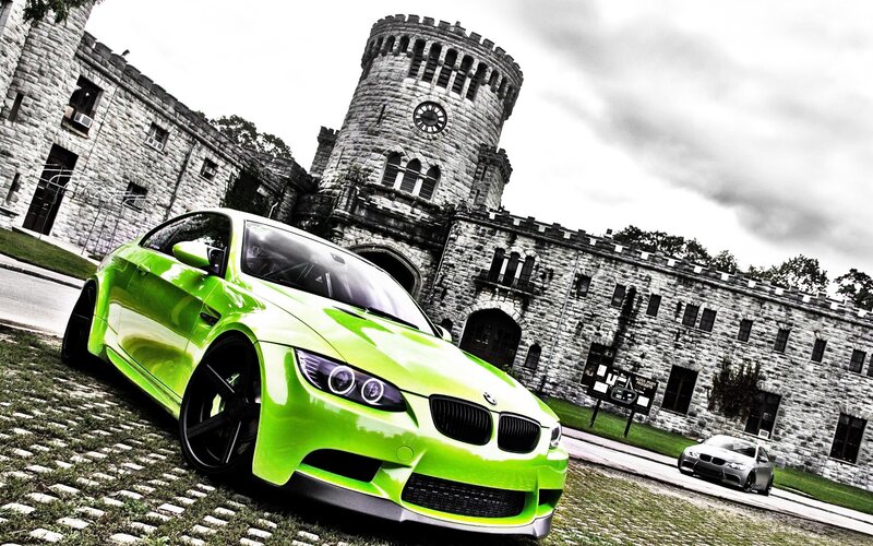 green bmw in front of castle