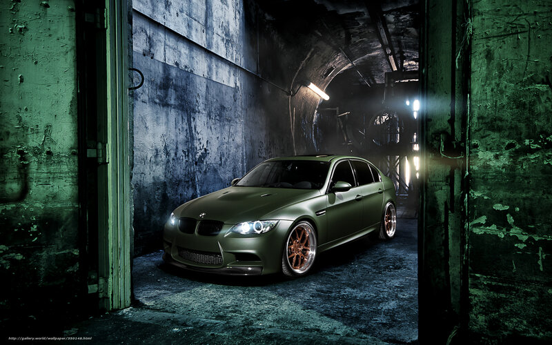 Green BMW in industrial tunnel