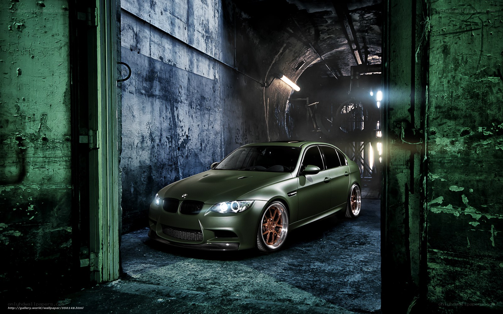 Green BMW in industrial tunnel