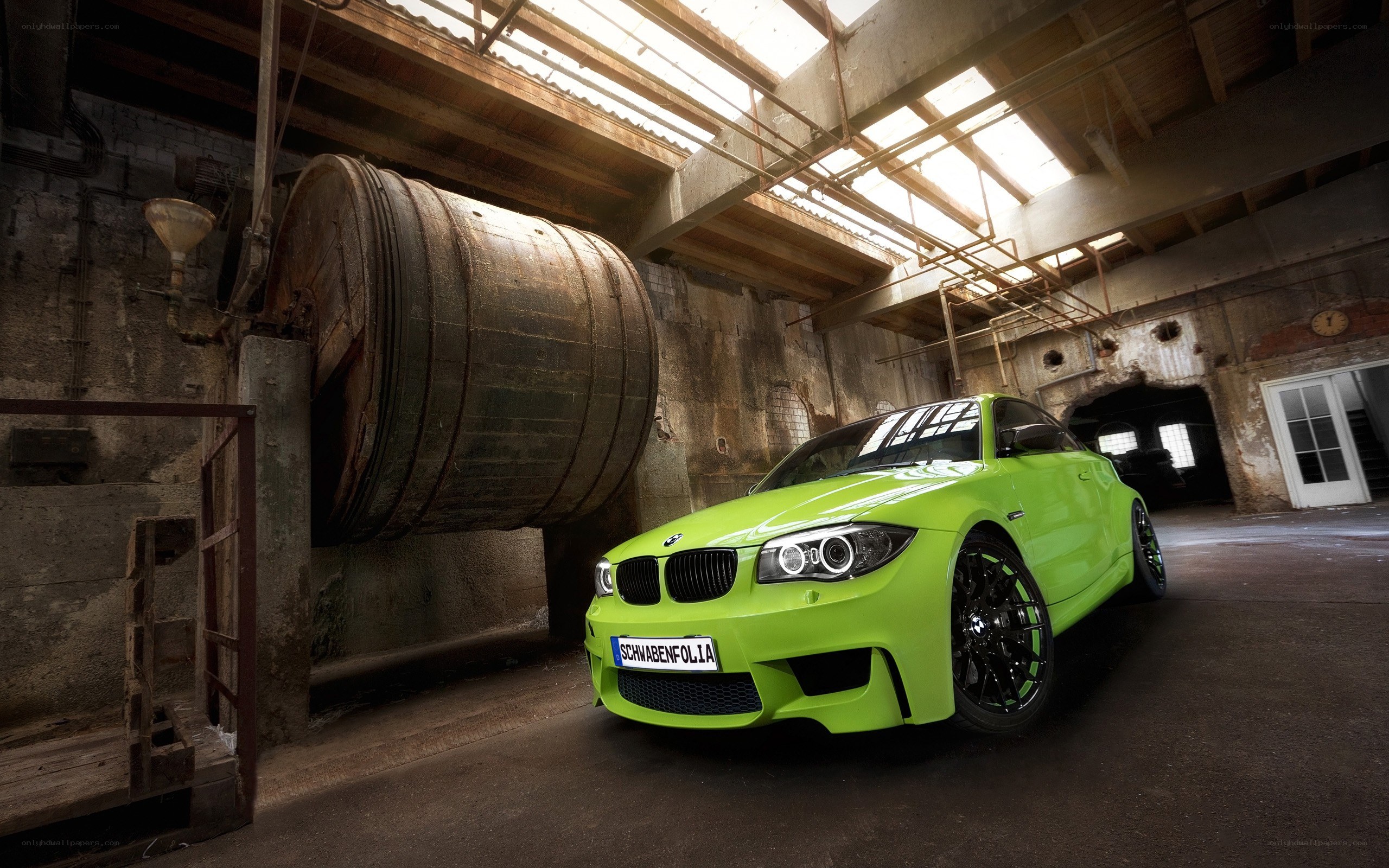 green bmw in industrial warehouse