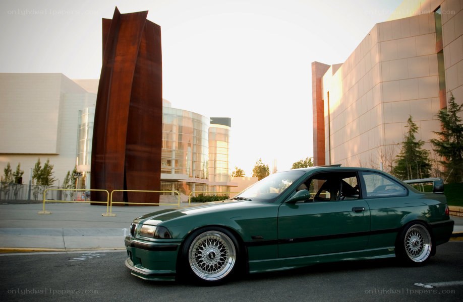 Green BMW in urban setting