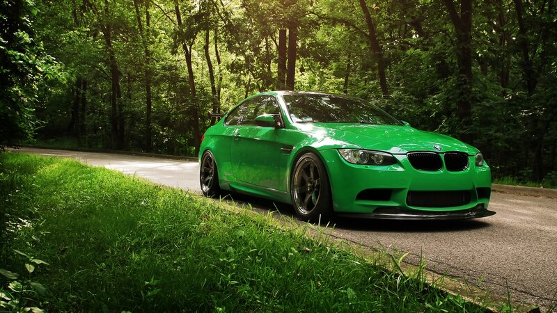 green bmw m3 in forest