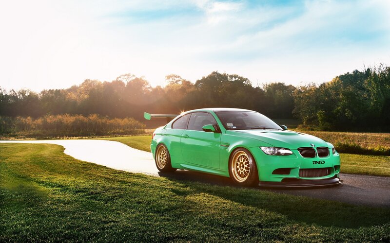 green bmw m3 on a country road