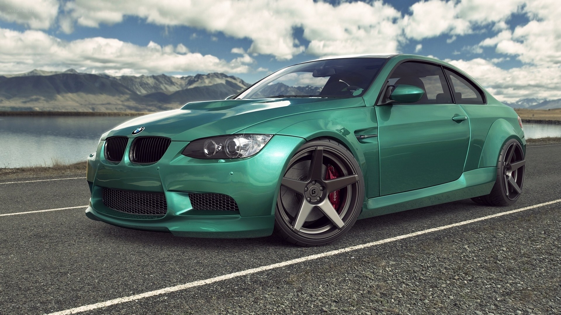 Green BMW M3 on a scenic road