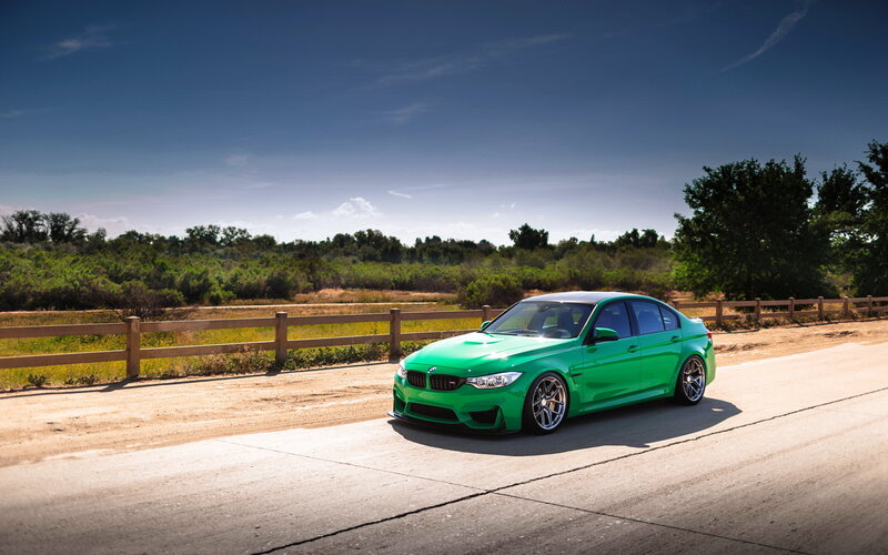 green bmw m3 on country road