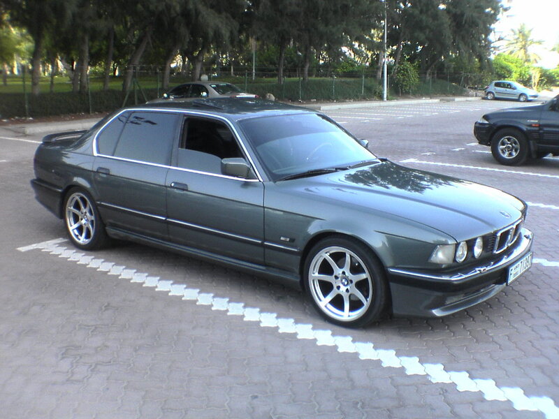 Green BMW parked in lot
