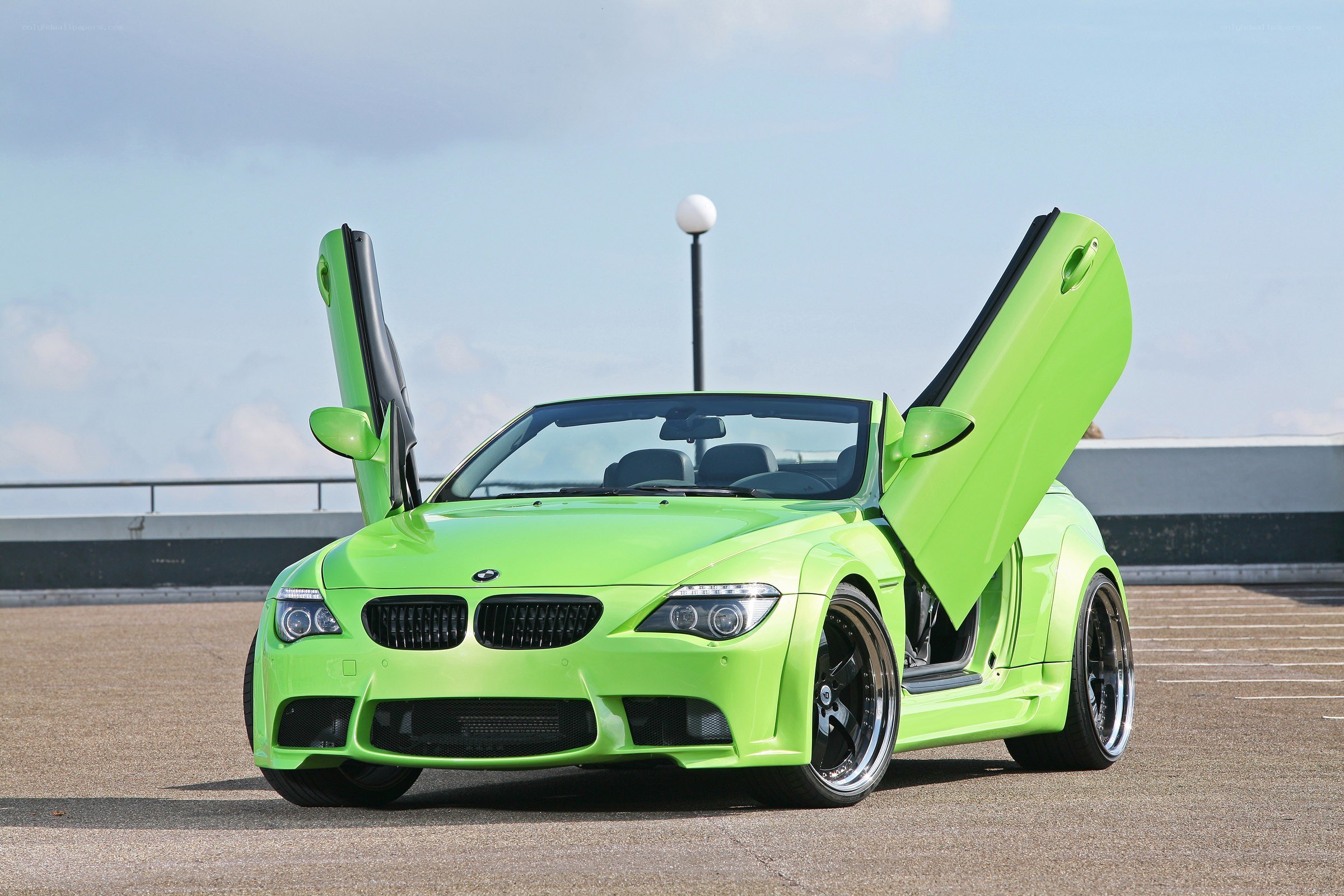Green BMW with doors open