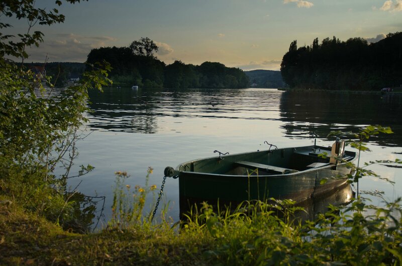 Green boat on a calm lake