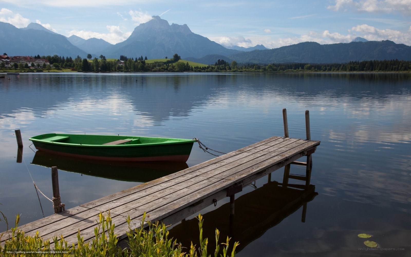 Green boat on a lake dock