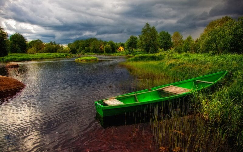 Green boat on a river