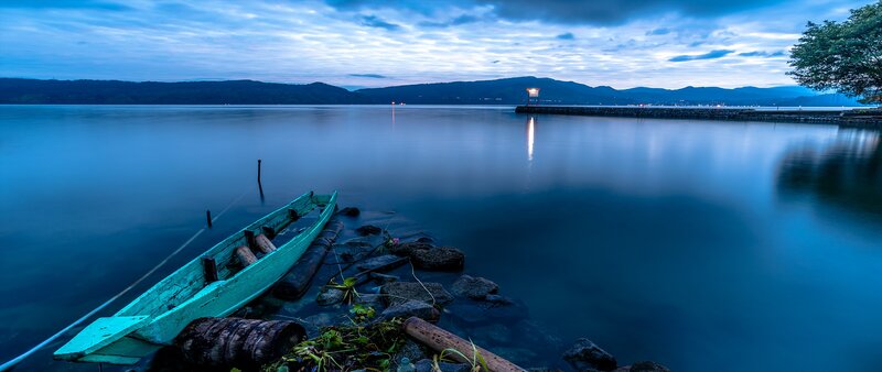 Green Boat on Lake Shore — Blue, Serene, Night, Photograph