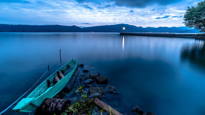 Green Boat on Lake Shore — Blue, Serene