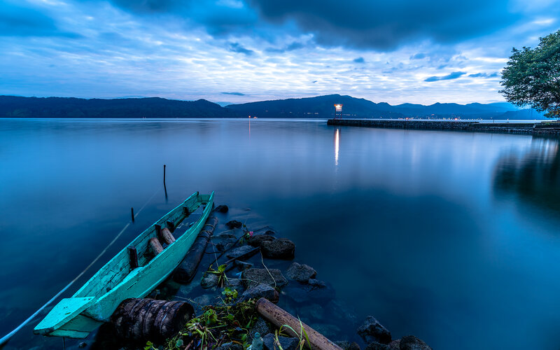 Green Boat on Lake Shore — Blue