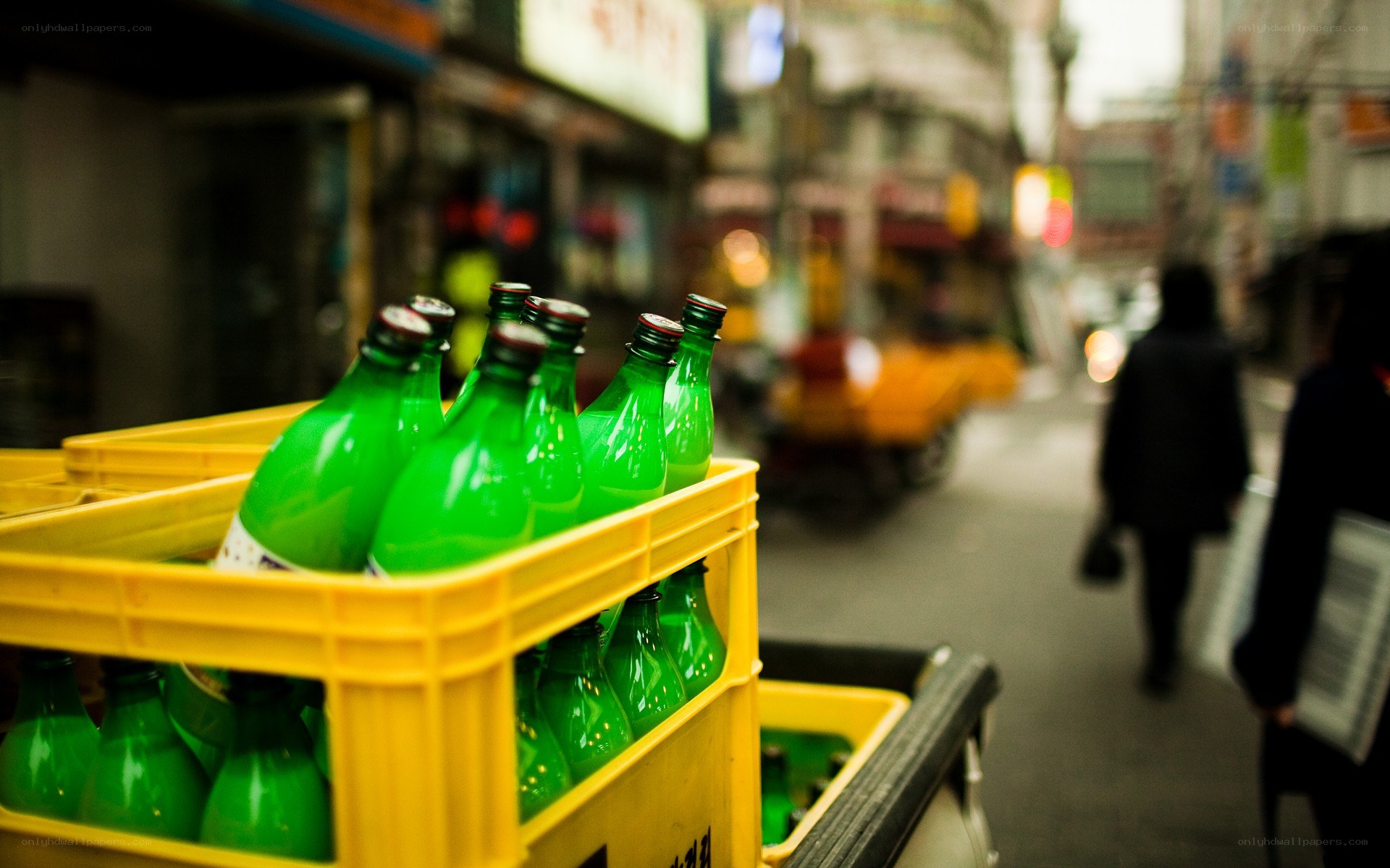 Green bottles in a yellow crate