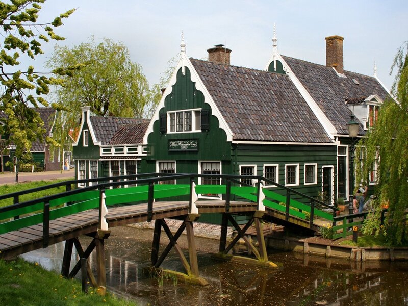 Green bridge over canal in Dutch village
