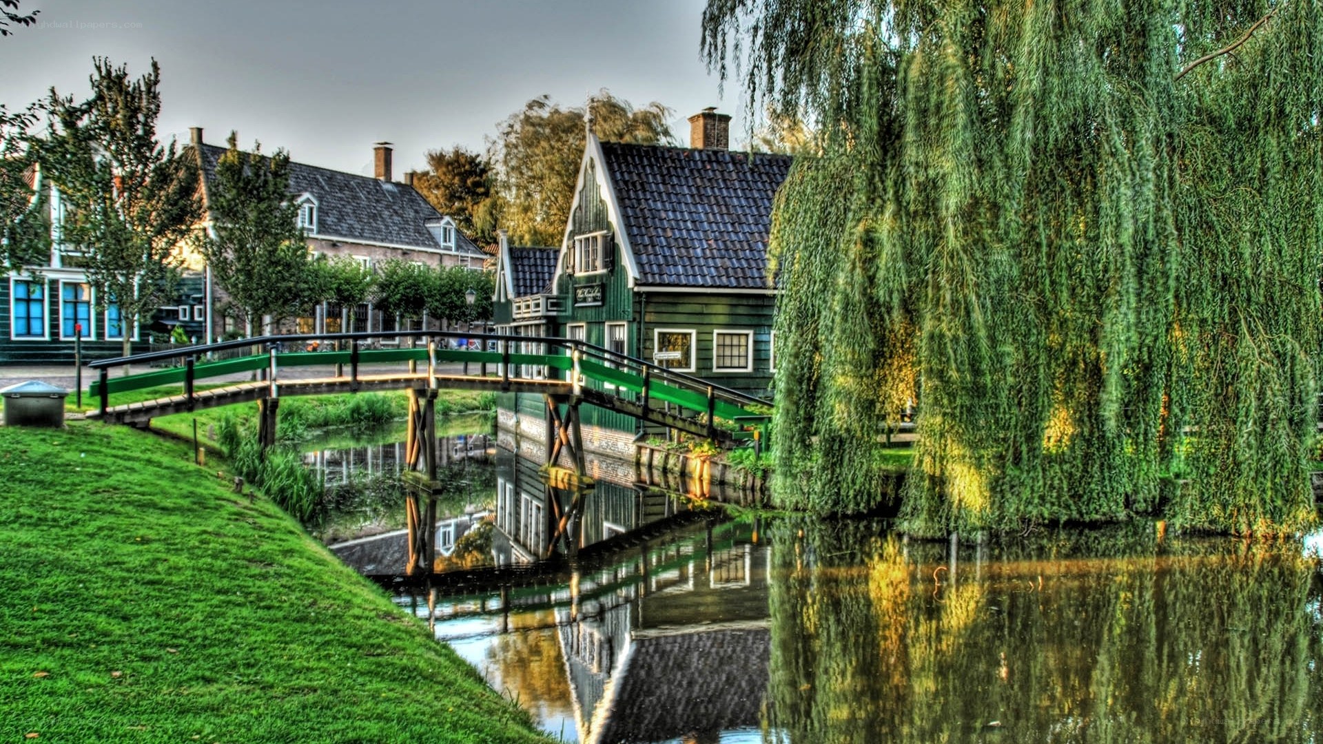 Green bridge over canal in village