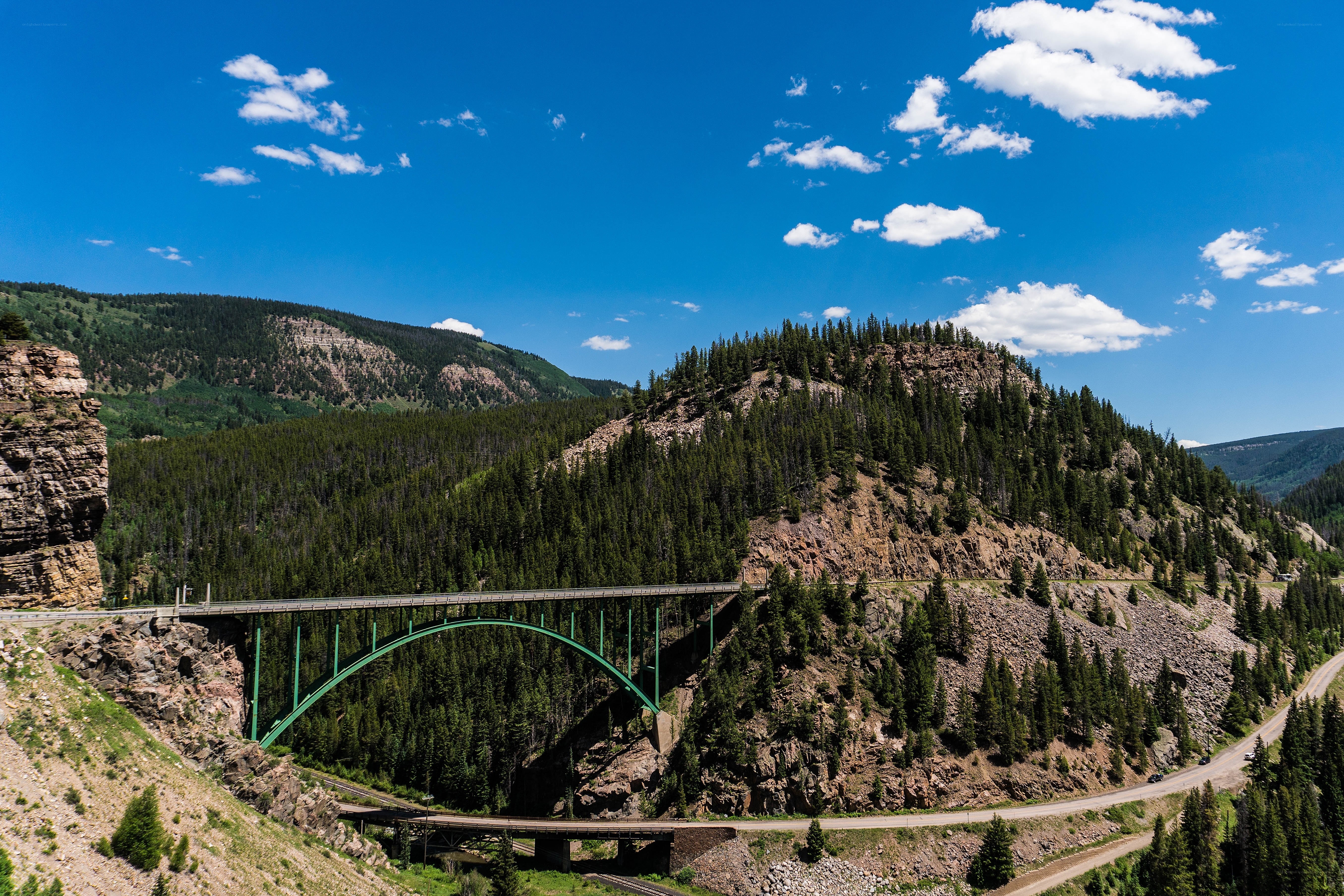 Green bridge over mountain valley