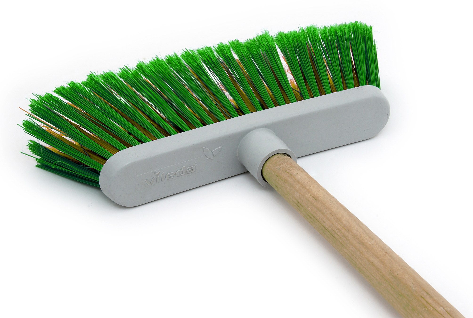 green broom with wooden handle