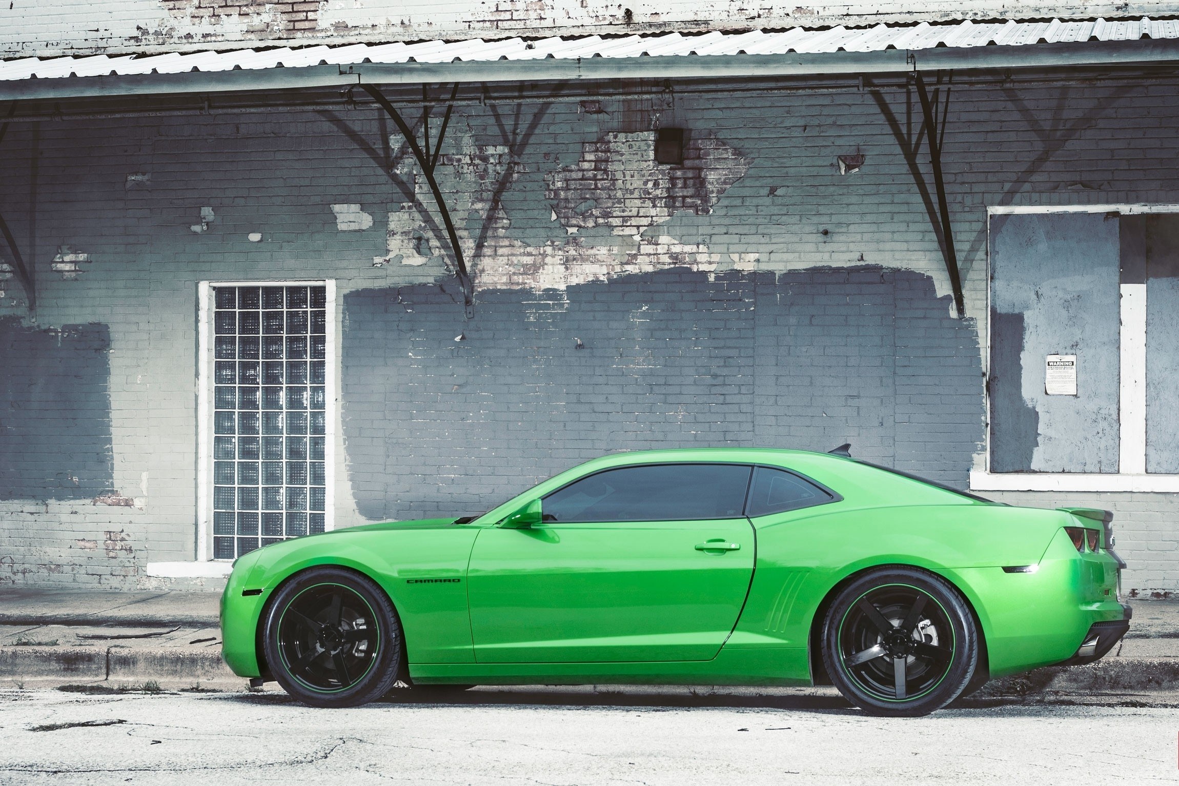 Green Camaro in urban setting