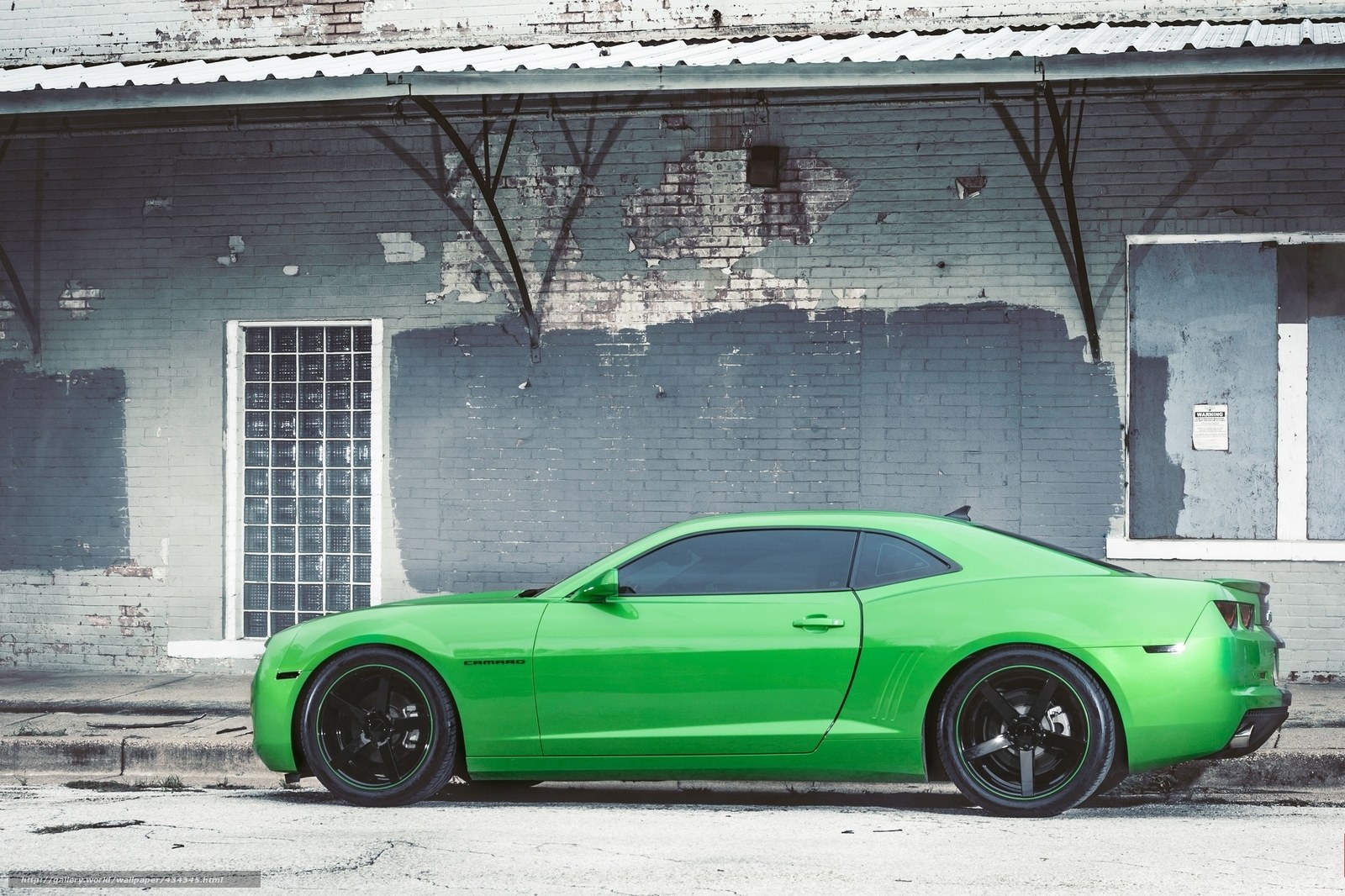 green camaro in urban setting