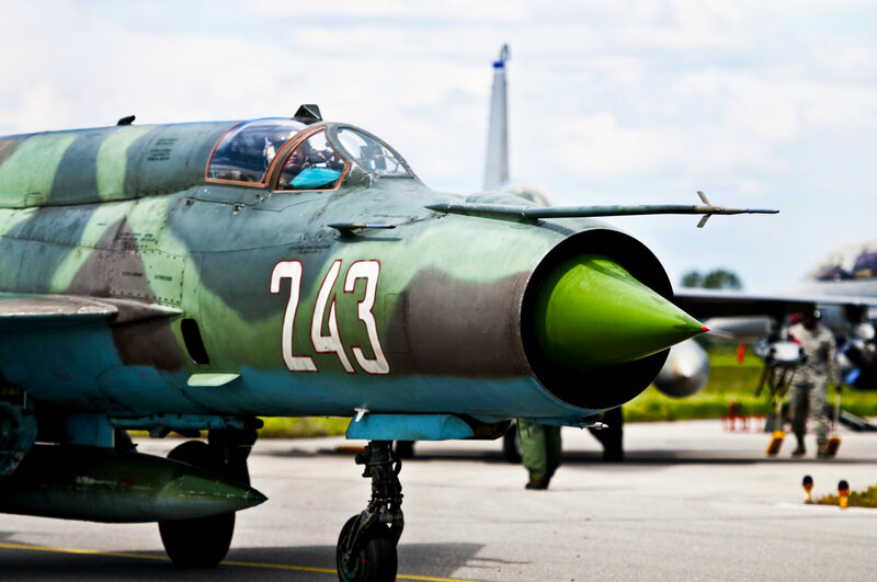 Green camo fighter jet on tarmac
