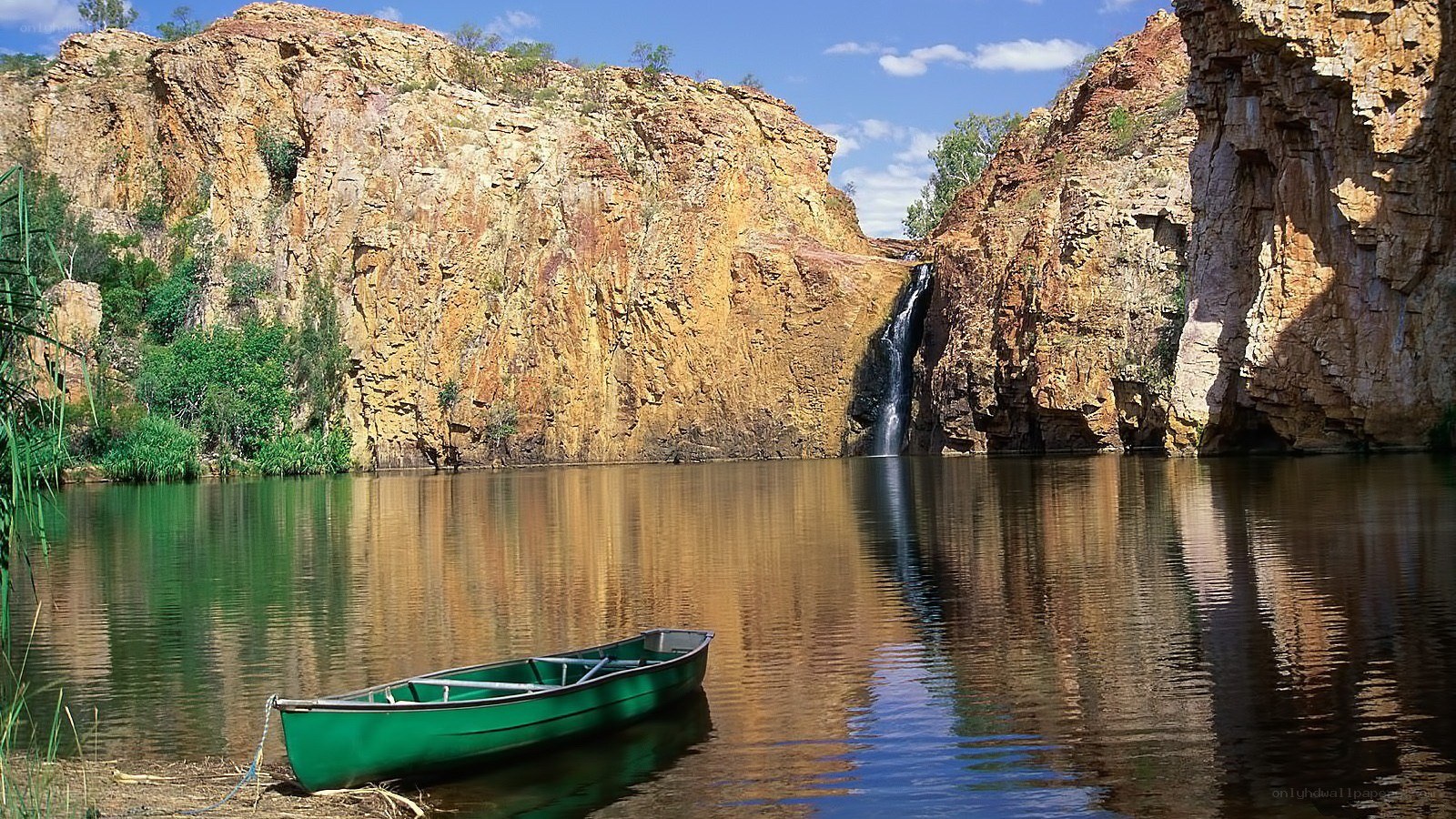 Green canoe at waterfall cove