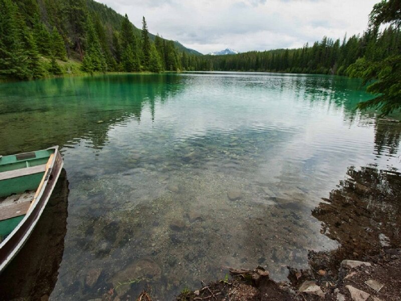 Green Canoe on Lake Shore