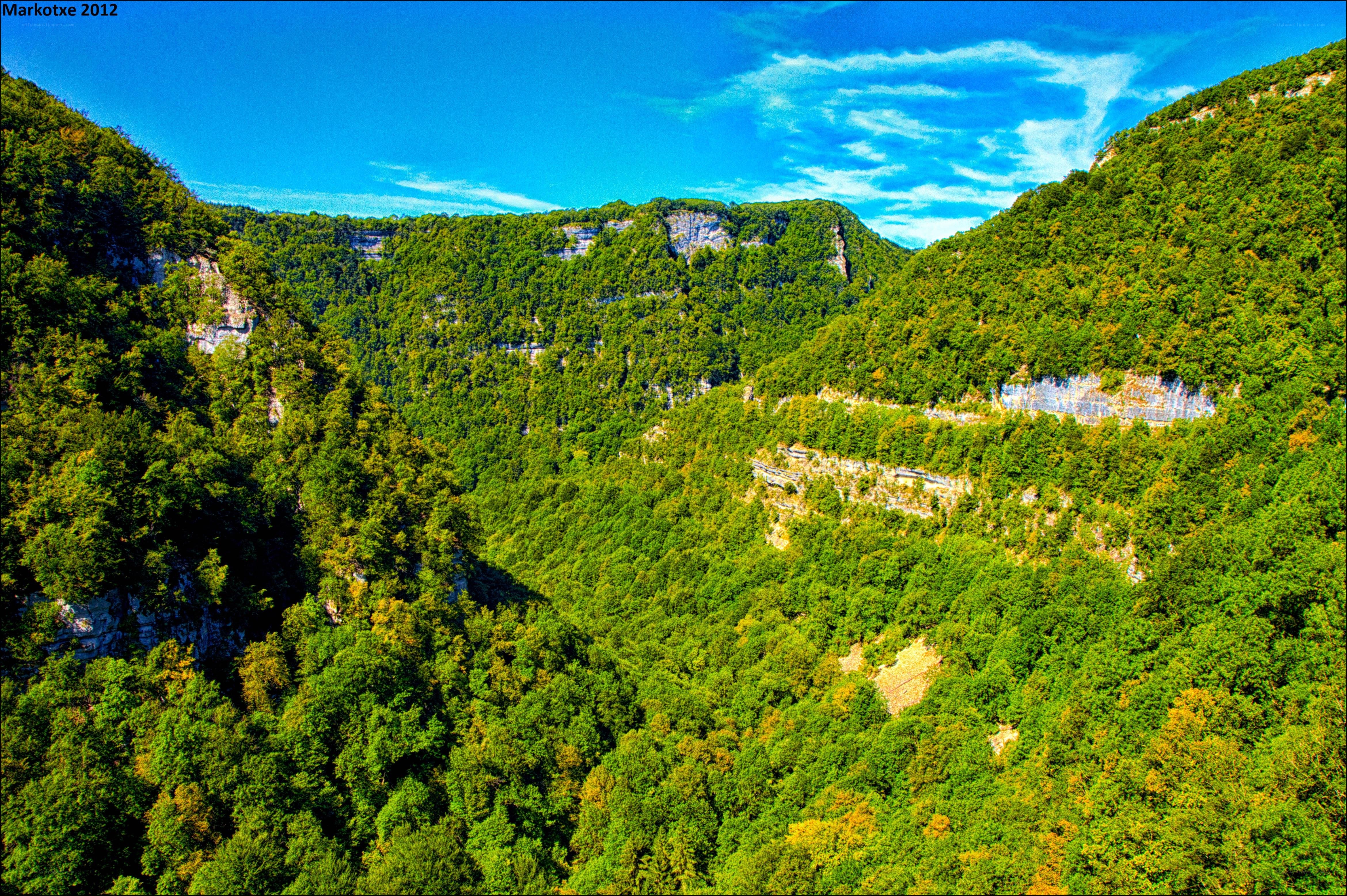 Green canyon under blue sky