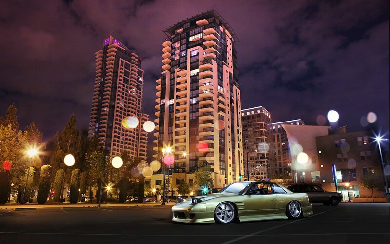 Green car at night in city