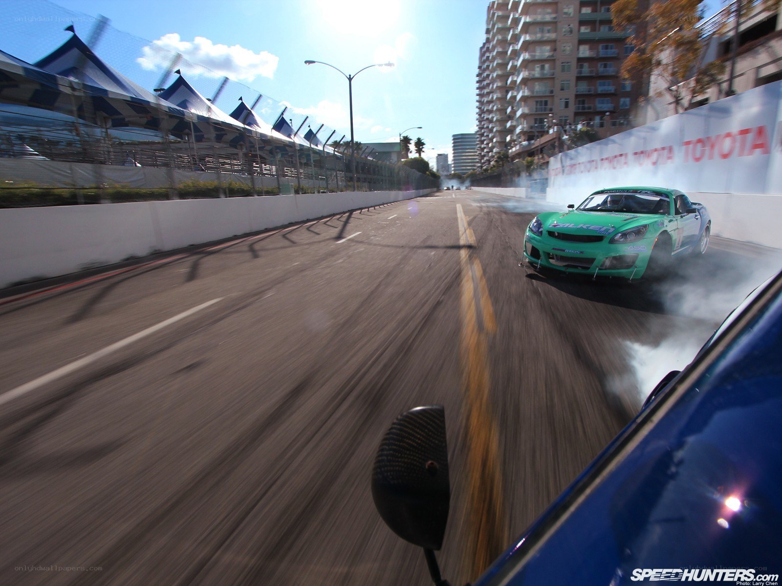 Green car drifting on track