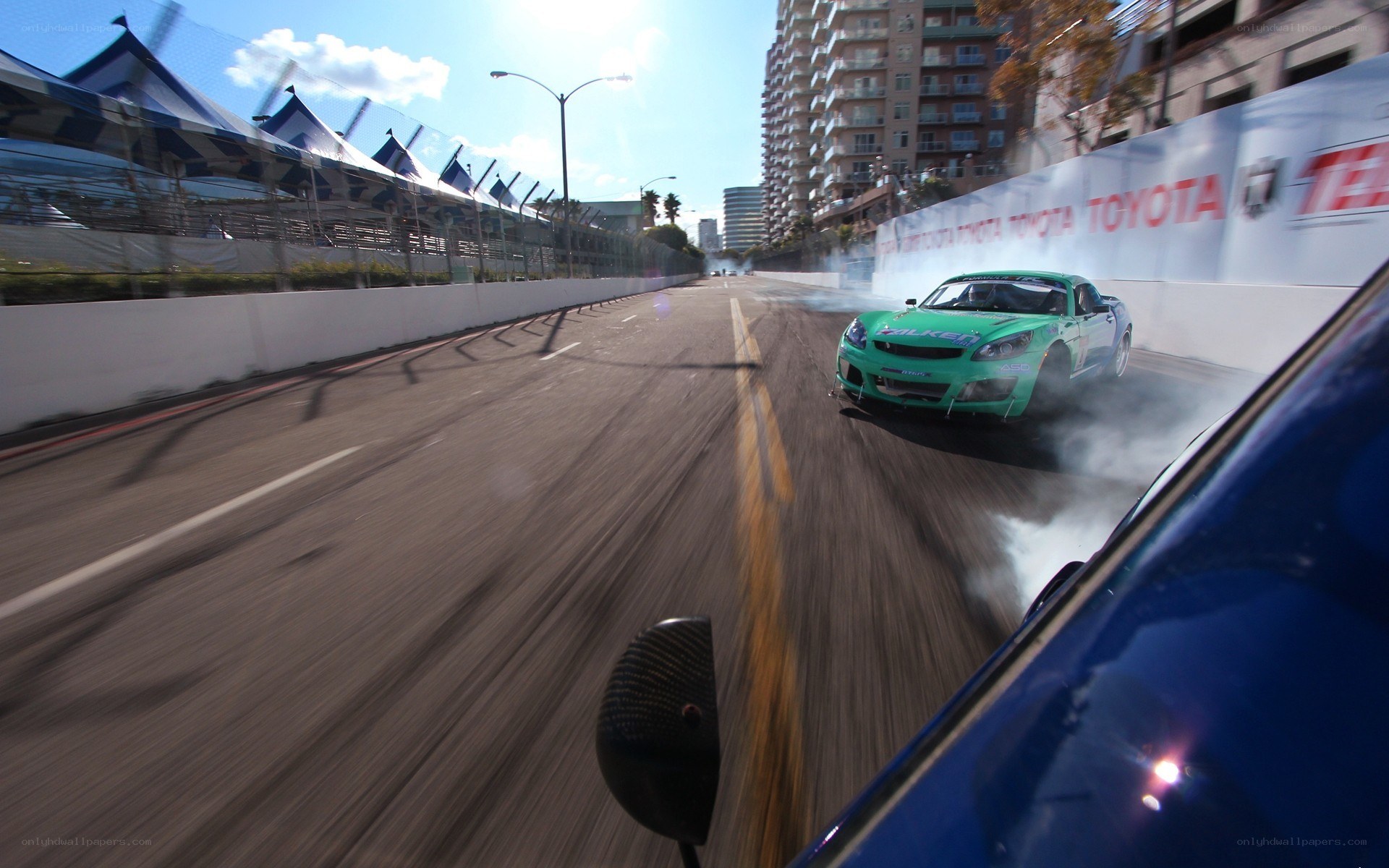 Green car drifting on track
