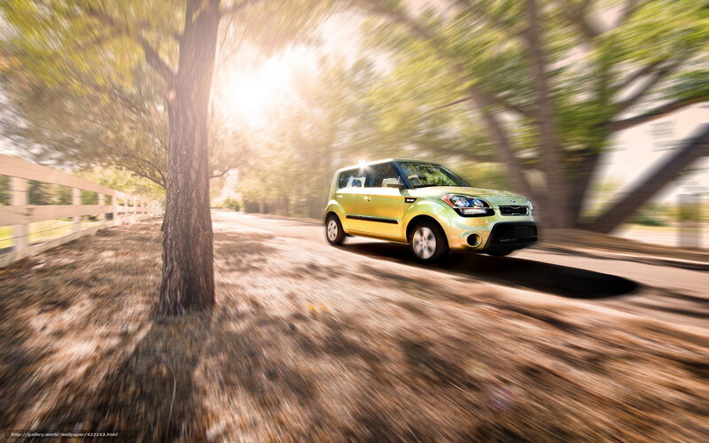 Green car driving on country road