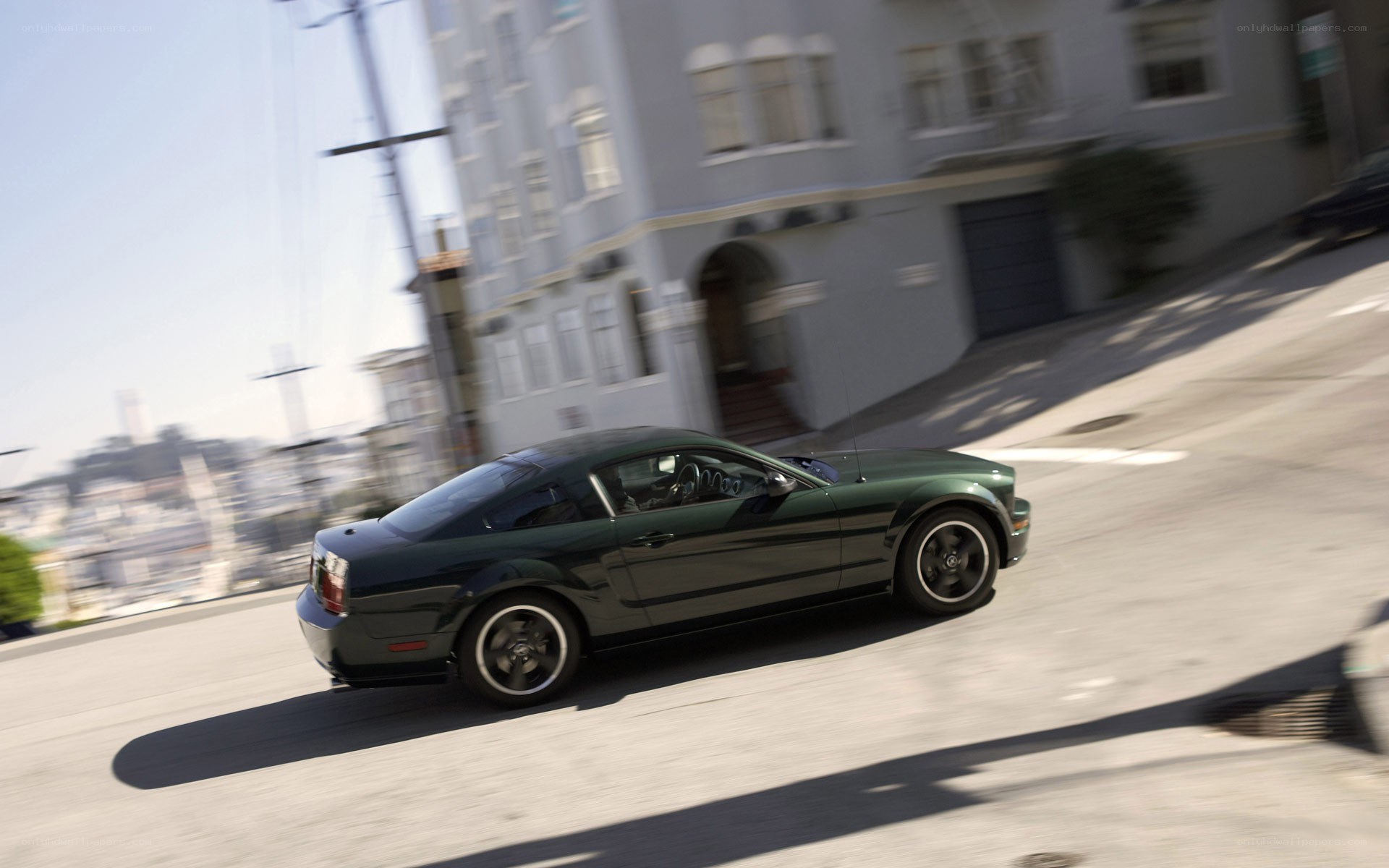 green car driving on street