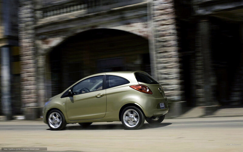 green car driving on street