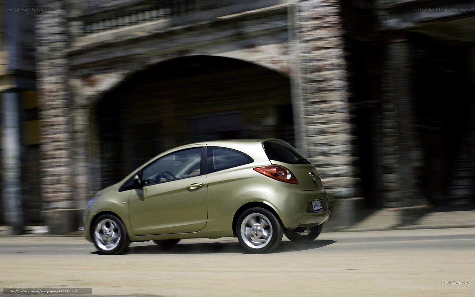 green car driving on street