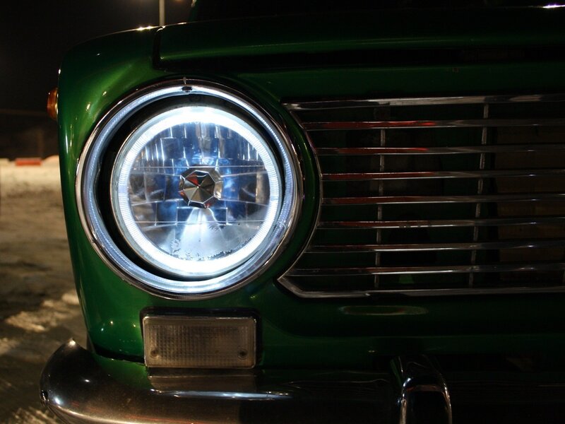 green car headlight at night