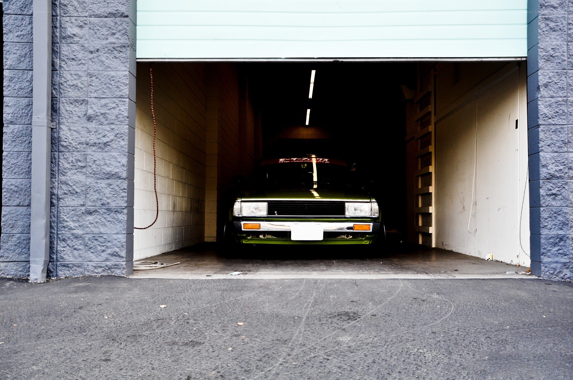 green car in garage