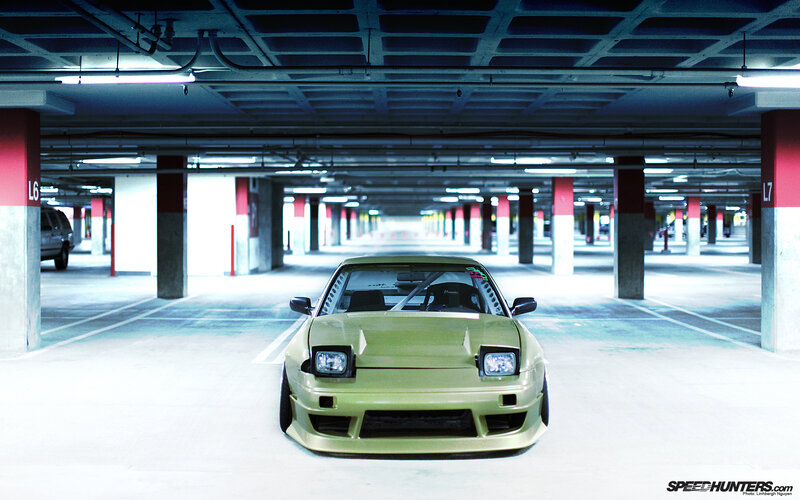 green car in parking garage