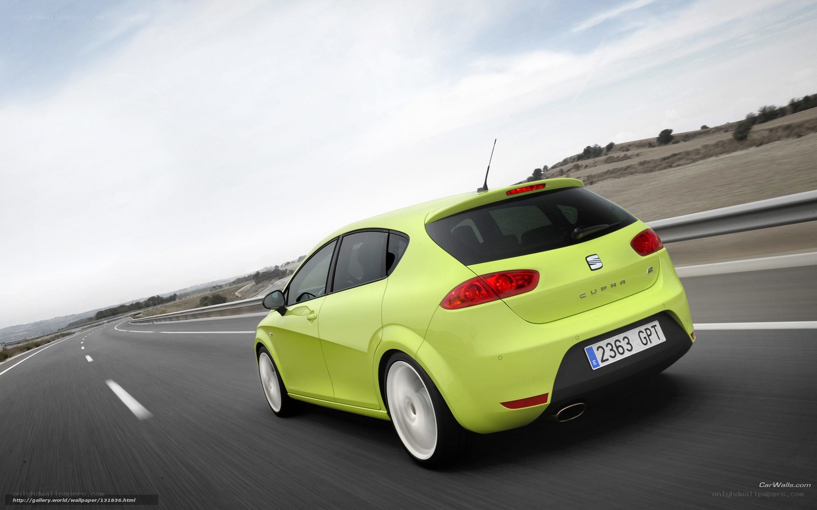 green car on a highway