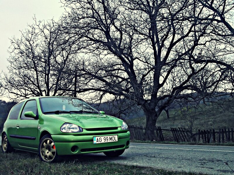 Green car on a rural road