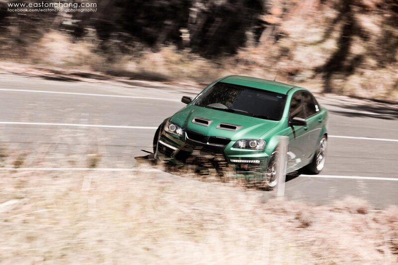Green car on a winding road