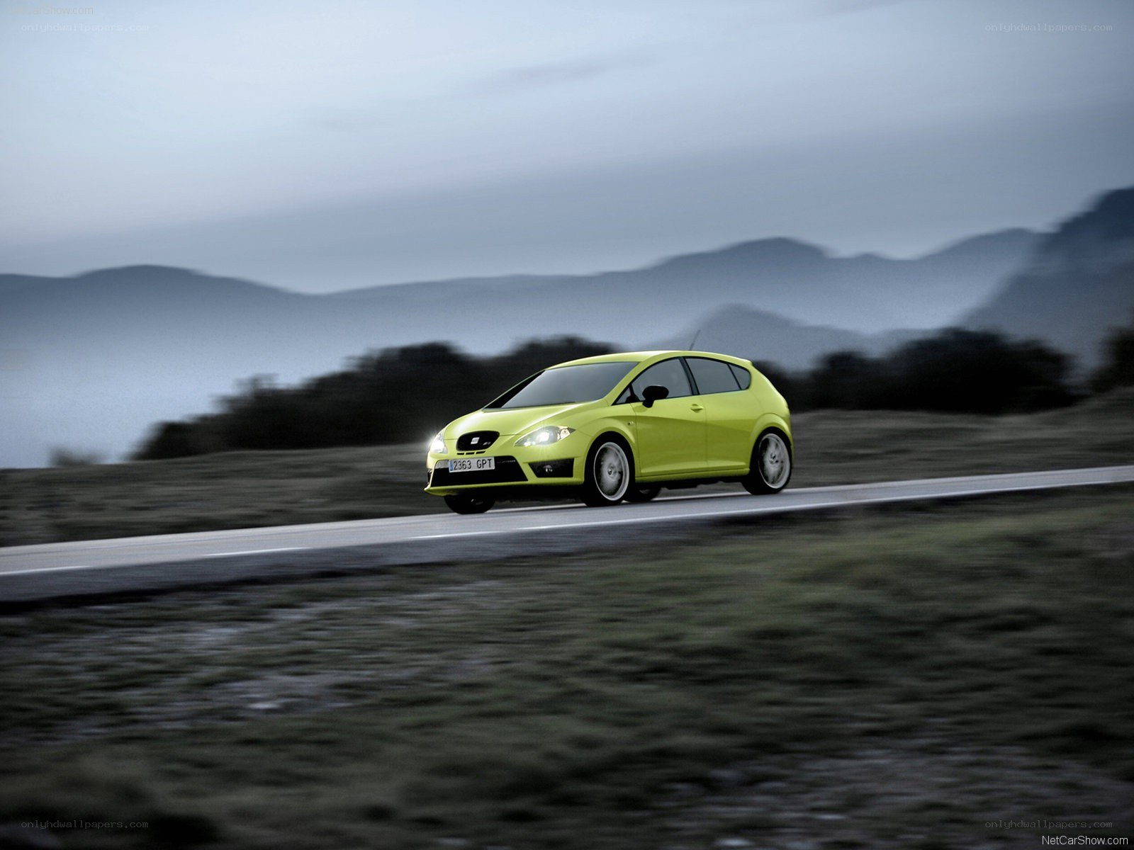 Green car on a winding road