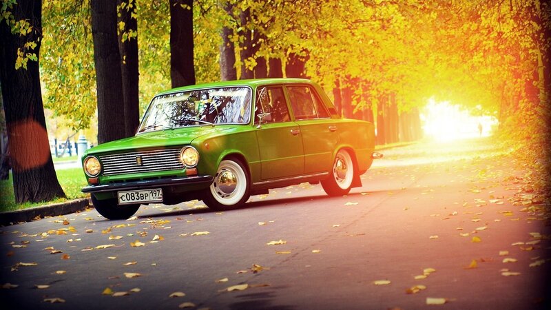 Green car on autumn street