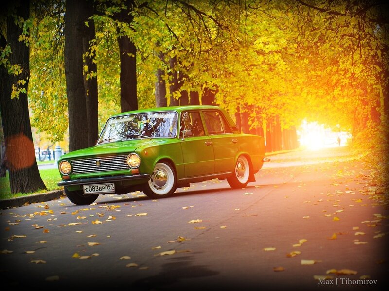 Green car on autumn street