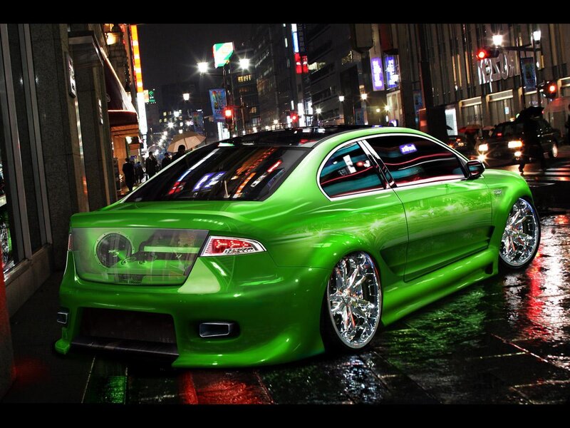 green car on city street